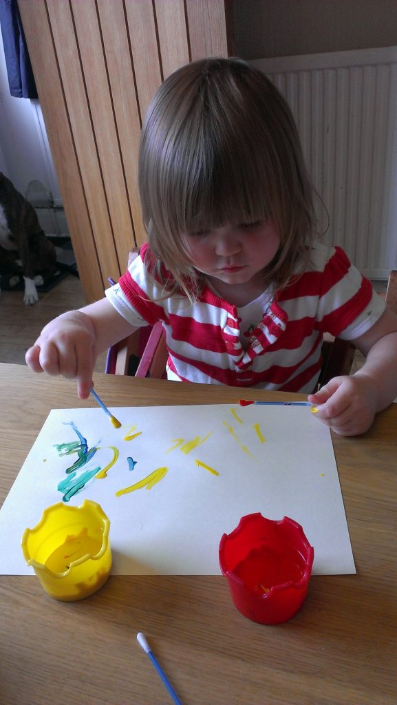 Toddler painting with cotton buds