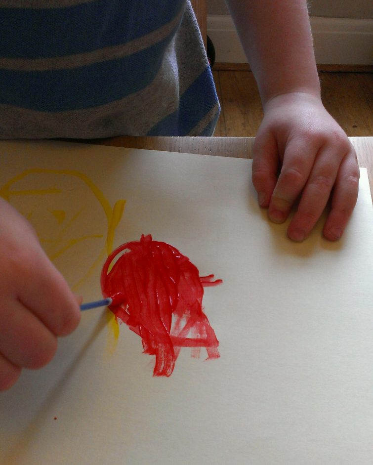 Painting with cotton buds and red poster paint