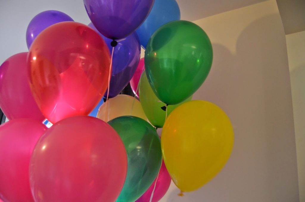bunch of brightly coloured helium balloons