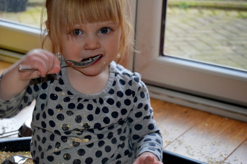 toddler with big spoon in mouth