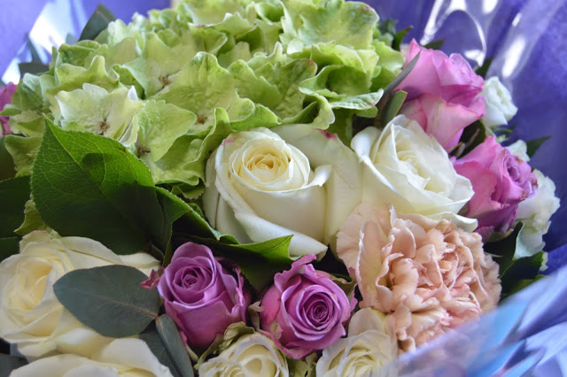 Close up of bouquet featuring hydrangea, roses etc.