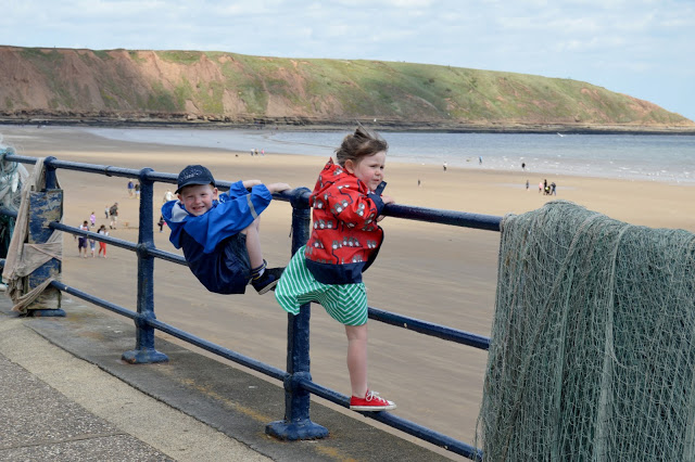 Kozi Kids waterproof jackets on a windy day in filey