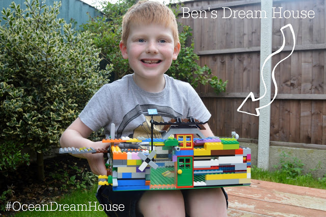 Little boy with his dream LEGO house