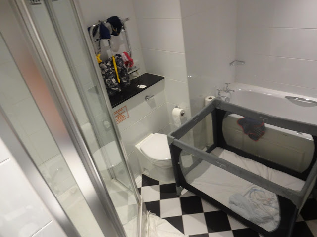 Put the travel cot in the hotel bathroom to give baby their own room!