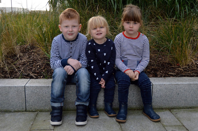 Little girls wearing matching bobux outback boots