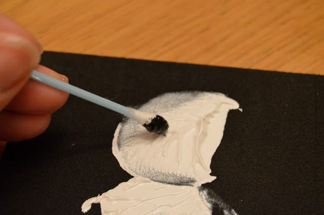 potato print snowmen - adding coal eyes