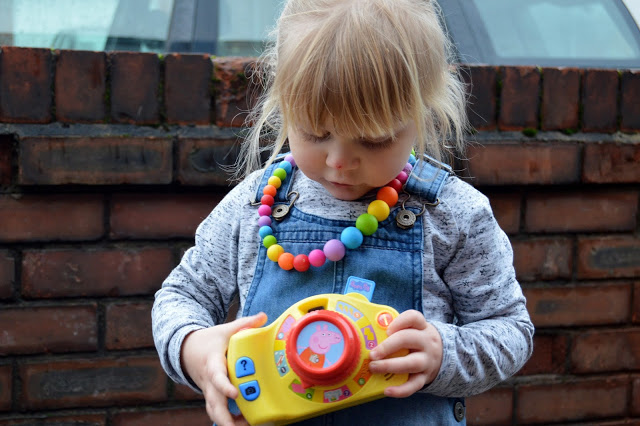 Toddler with Peppa Pig toy camera