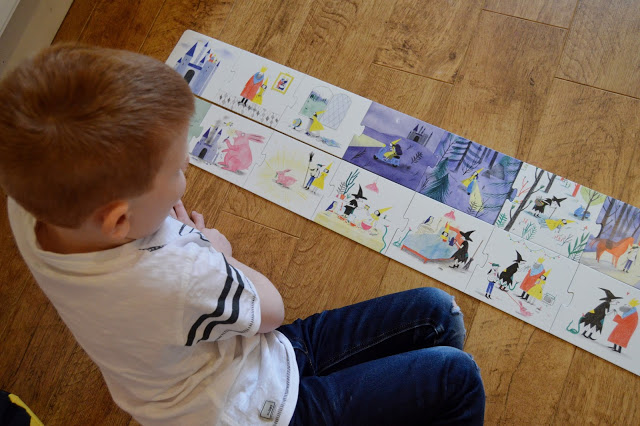 Little boy using Story Box jigsaw pieces to make his own story