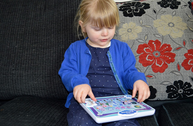 Toddler with Frozen tablet toy