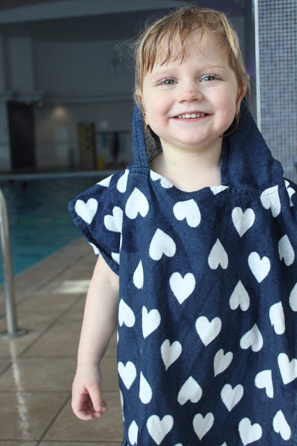 Little girl in towel smiling after her Puddle Ducks Kickers lesson