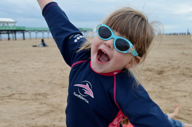 Chloe wearing Konfidence sun protection suit on the beach