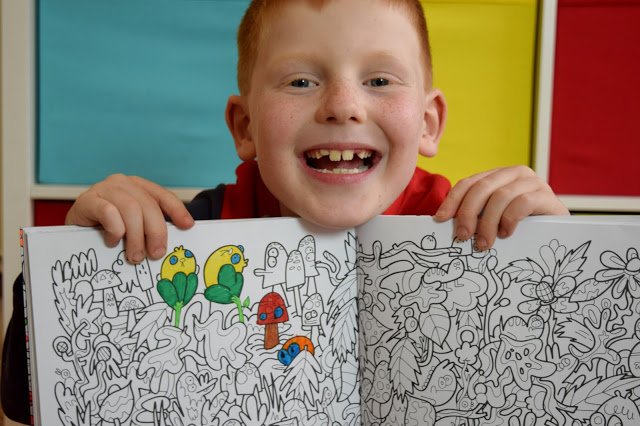 boy showing his colouring in