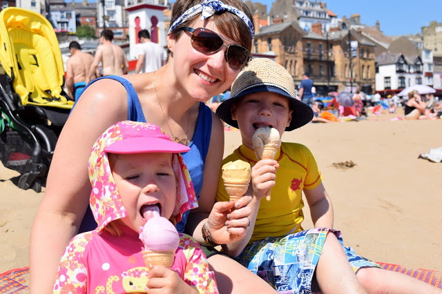 family on the beach eating ice cream