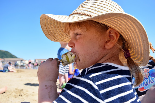 toddler eating lolly on the beach