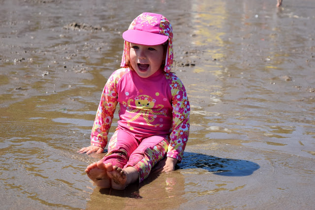 little girl sat on the sand