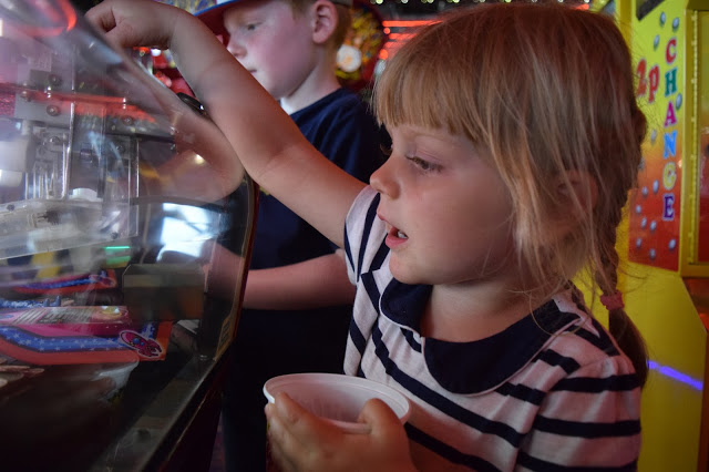 Little girl playing the 2p machines in Scarborough