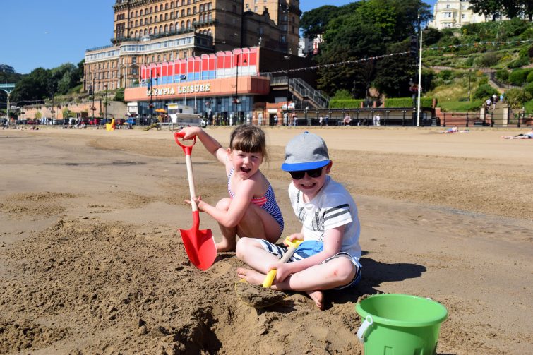kids digging on beach in Scarborough