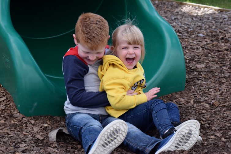 Siblings on slide at York Maze