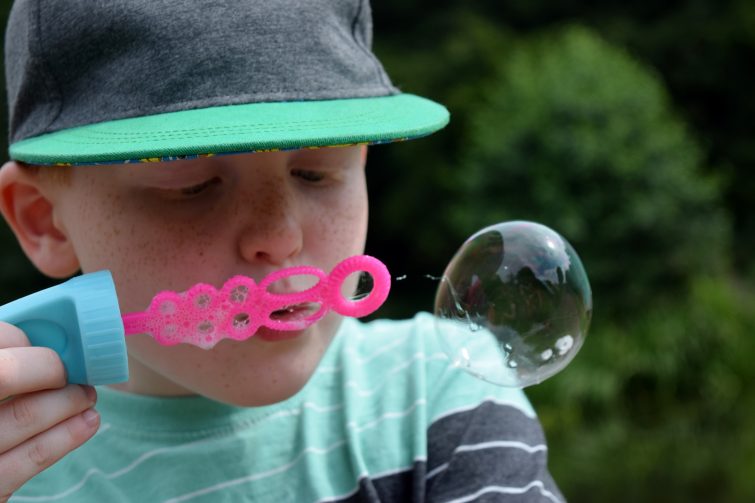 Boy blowing bubbles