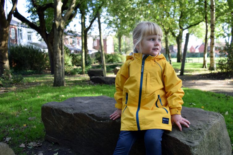 toddler wearing a yellow coat