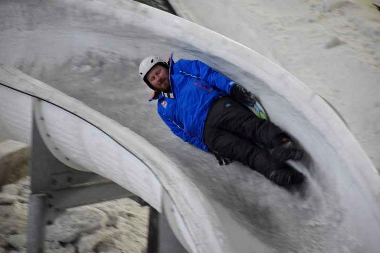Tall man on Luge - indoor snow fun
