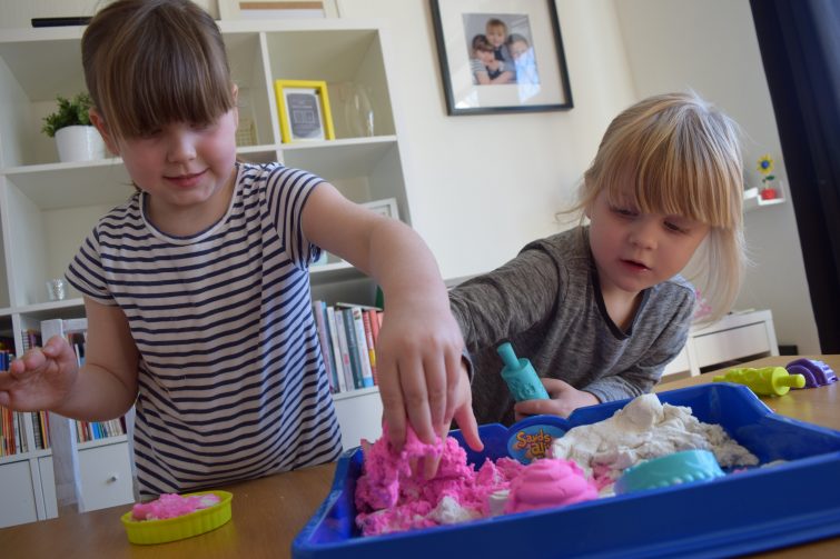 Sisters playing with Sands Alive Cake Shop