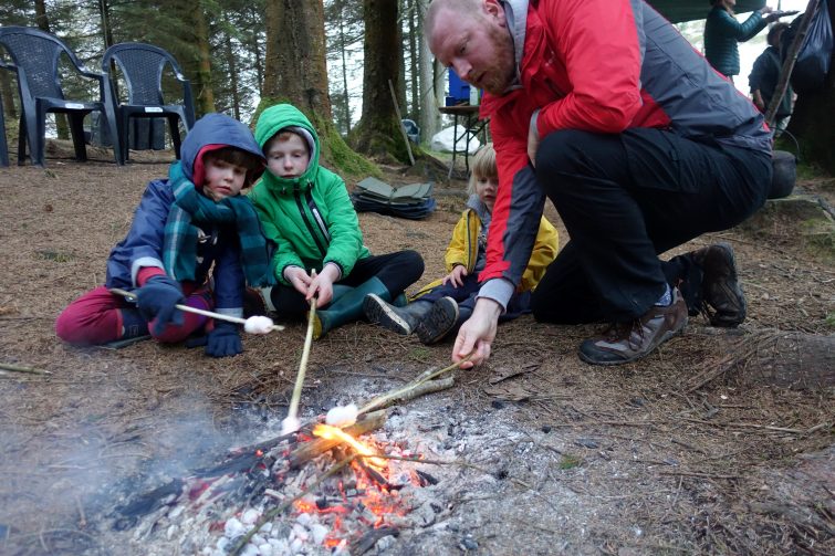 toasting marshmallows on an open fire