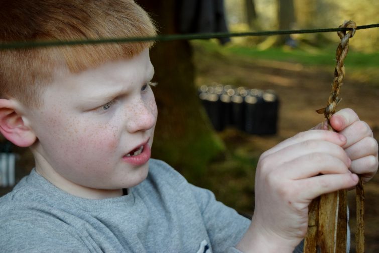 Making string from natural materials at camp Woodsmoke / Wild human