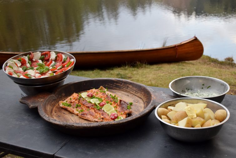 A campfire feast of new potatoes, salmon and tomato salad!