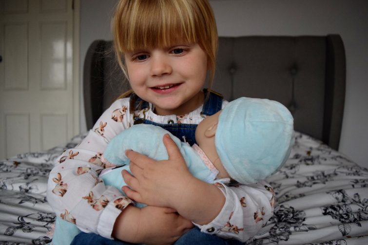 Cuddles with Baby Annabell's brother