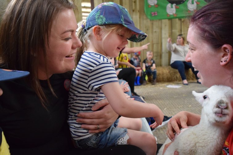 Stroking lambs at Smithills Open Farm with Piri Allergy