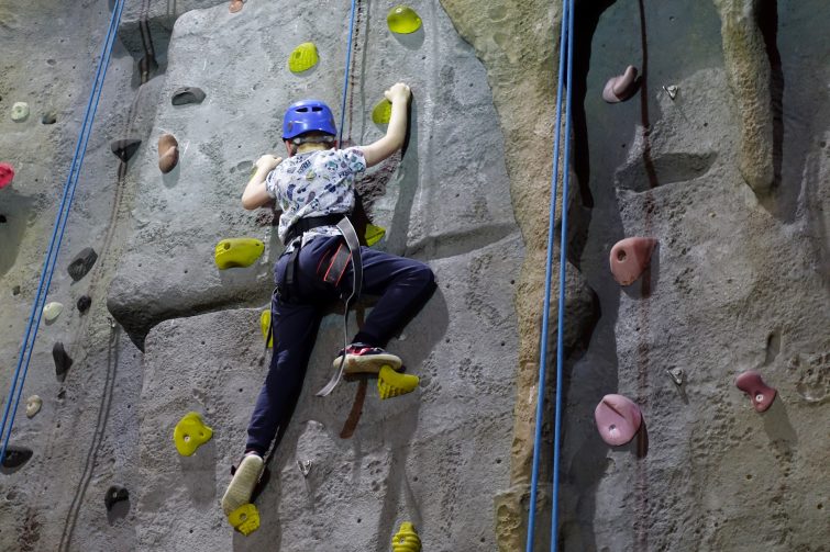 Ben climbing the yellow path of the climbing wall at Chill Factore