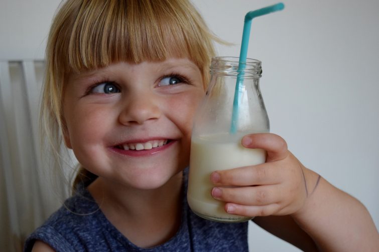 Happy little girl drinking Arla Organic Free Range milk