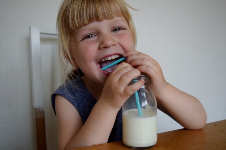 Little girl drinking Arla Organic Free Range milk