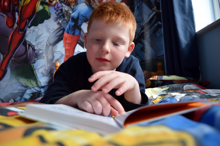 Boy reading #StartAStory Puffin Summer Reading campaign