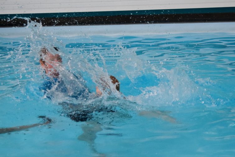 Little girl making a big splash in her swimming lesson