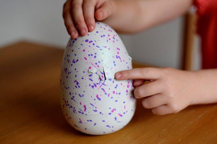 The Hatchimal taps its way through the egg shell