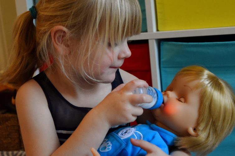 Feeding Cicciobello some milk to make him feel better