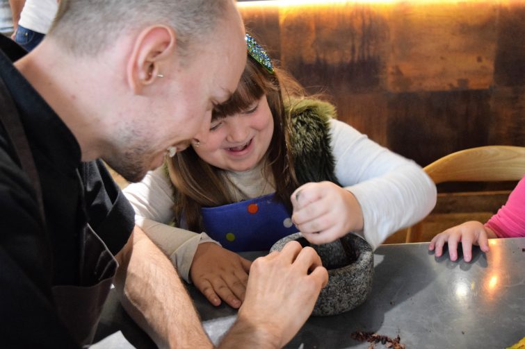Hotel Chocolat Children's Chocolate Workshops - grinding cocoa beans