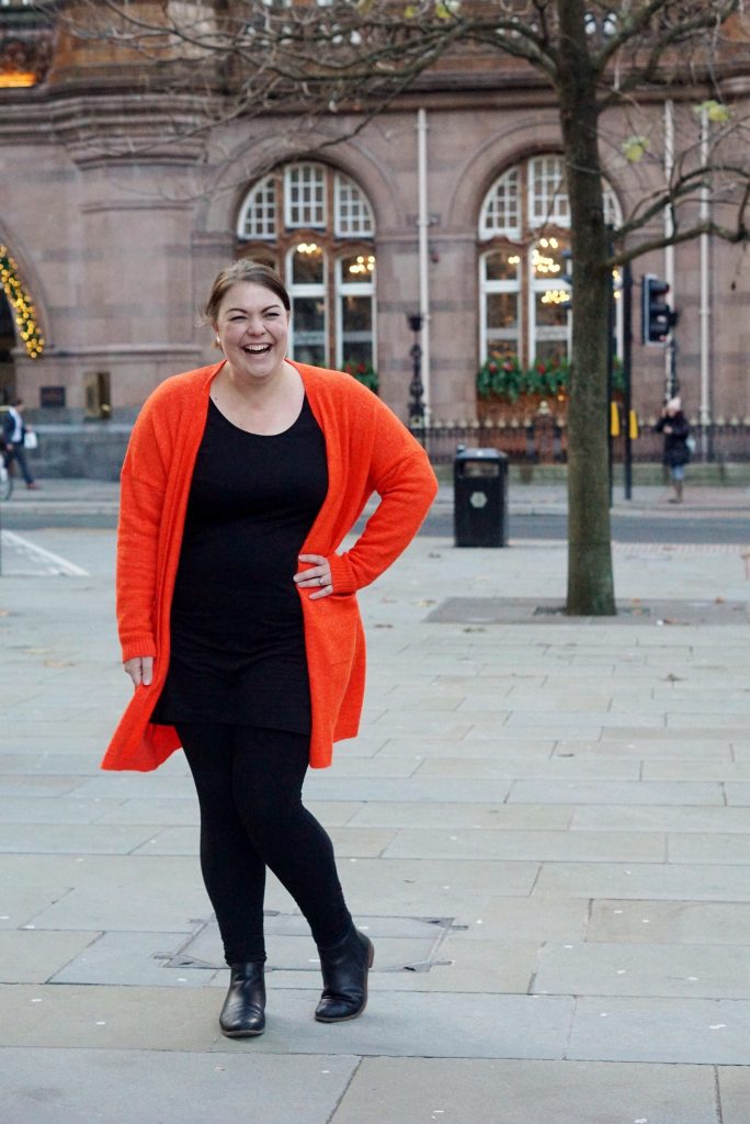 Black jersey basics with orange cardigan
