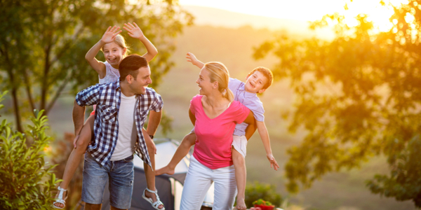 A family having a good time whilst the sun sets.