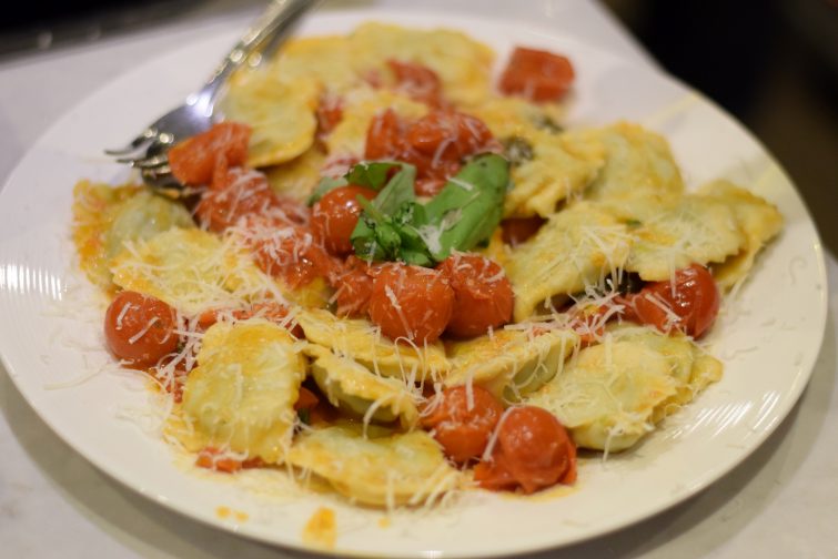 Freshly made spinach ravioli with an Italian tomato sauce