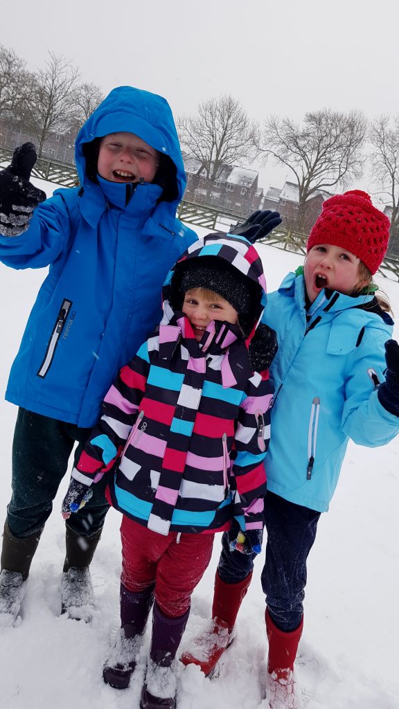 wrapped up in the snow wearing Reima winter coats