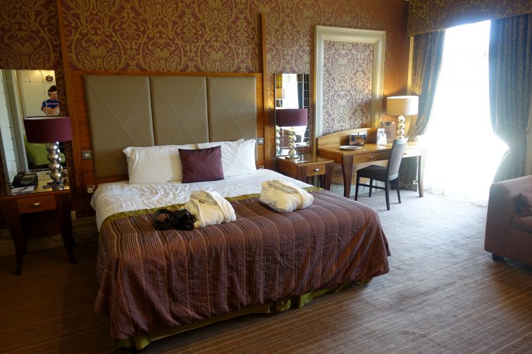 Large windows and enormous bed in Deluxe Garden View room - Harrogate hotel