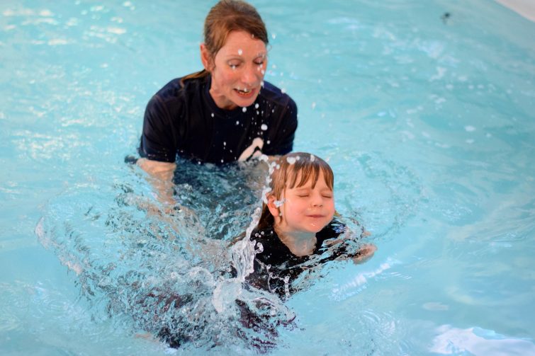 Puddle Ducks Swim Academy Pyjama Week reaching for the side