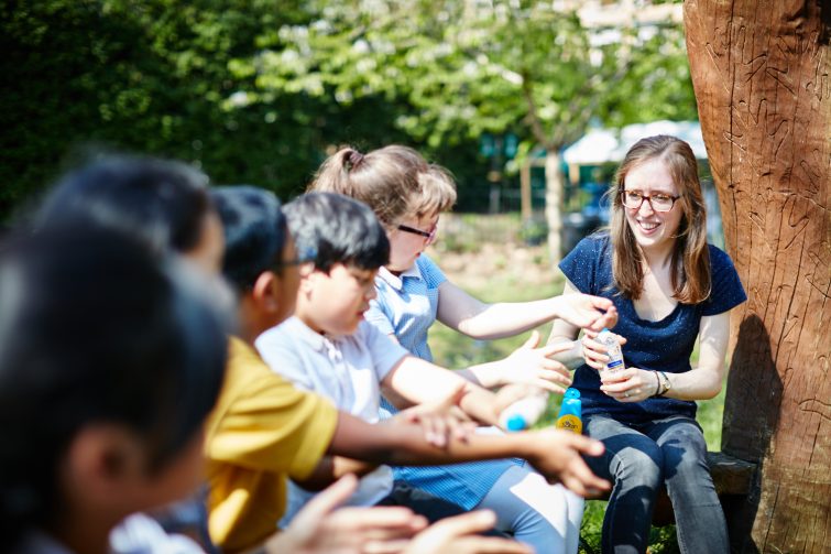 Children applying suncream at school