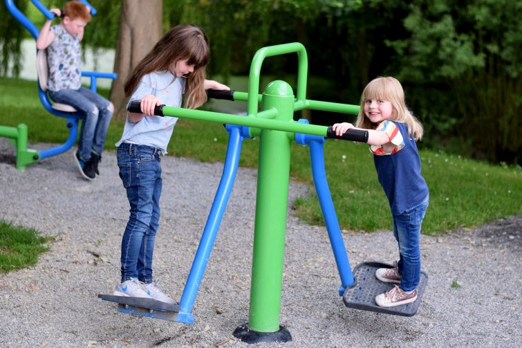 Children trying out the fitness equipment at Chateau de Lez Eaux campsite