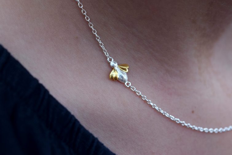 Close up of Molly Brown honey bee necklace - beautiful golden wings