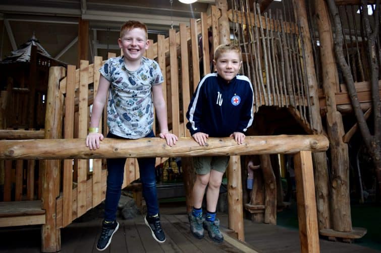 William's Den indoor play space features a large wooden climbing frame