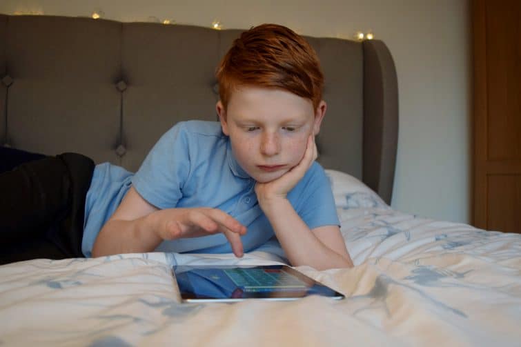 Boy practising times tables on tablet